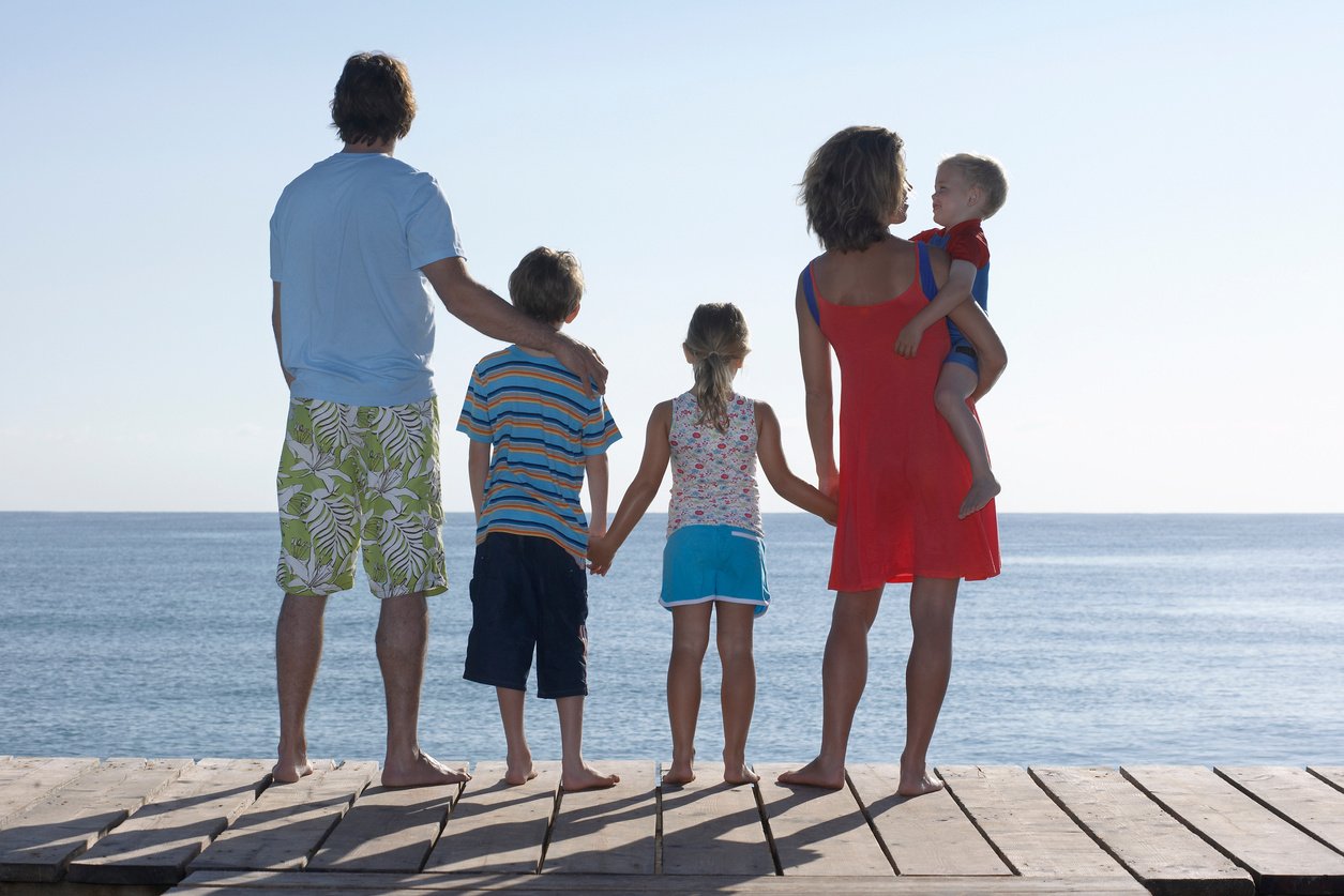 Couple With Three Kids Standing On Jetty